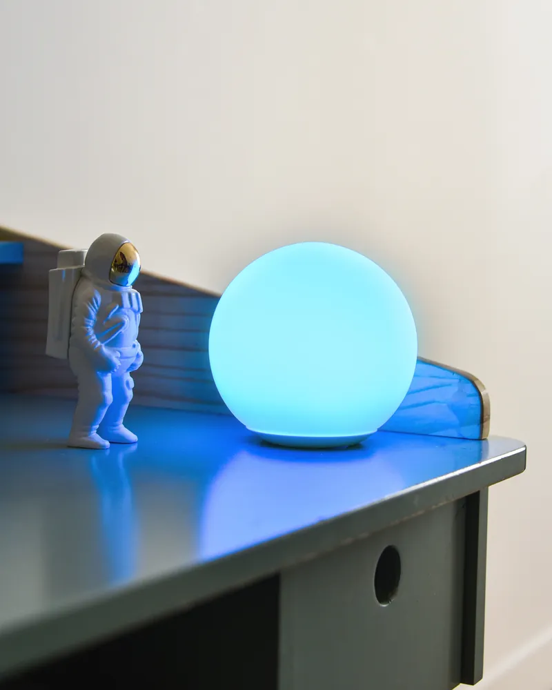 SensoLight glowing blue on a white desk